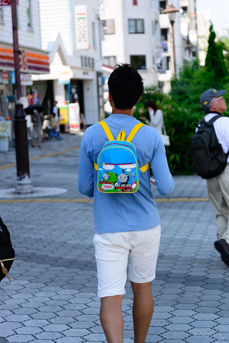 Mochila infantil nas costas de um adulto, imagem ilustrativa sem relação com o caso